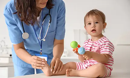 A photo of a medical professional attending to a toddler.